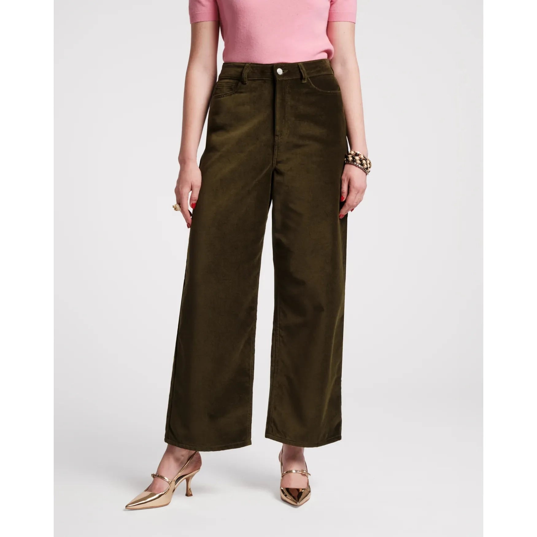 Person wearing olive green wide-leg pants and a pink top on a white background