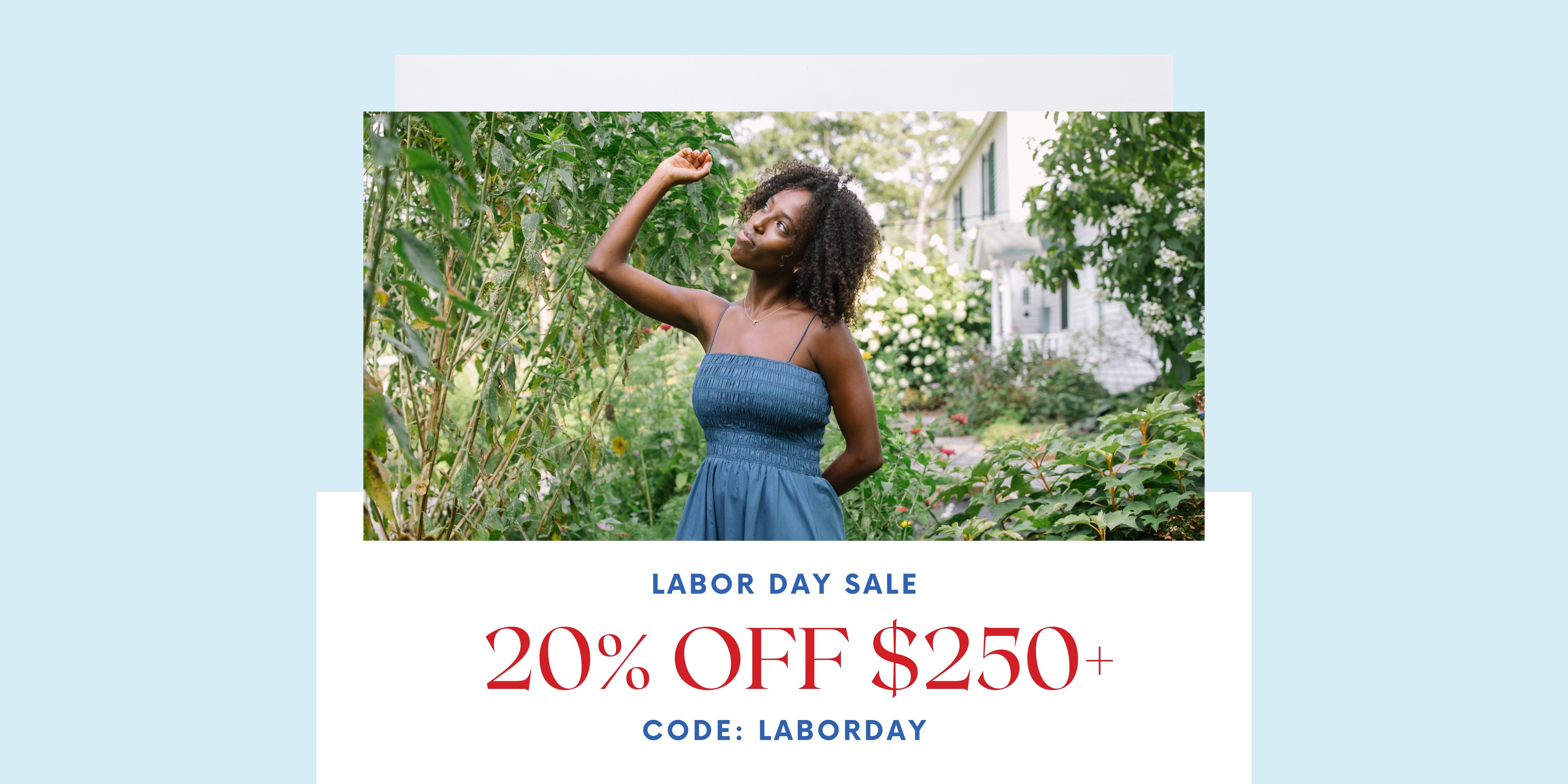 Woman in a blue dress standing outdoors with Labor Day sale text overlay