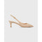 The Ann Mashburn Kitten Heel Slingback in pebble suede showcases a retro allure with its pointed toe and mid-height heel. Crafted from sumptuous lambskin leather, it includes an adjustable ankle strap with a gold buckle, echoing the classic Mary Jane style. The shoe is elegantly presented on a plain white background.